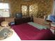 Cozy bedroom featuring floral wallpaper, a dresser, and a bright window at 2610 Marywood Dr, Southport, IN 46227