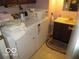 Functional laundry area with washer, dryer, sink, and storage at 2610 Marywood Dr, Southport, IN 46227