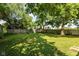 A well-maintained backyard enclosed by a classic wooden fence and shaded by mature trees at 2702 S Moreland Ave, Indianapolis, IN 46241