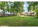 Grassy backyard featuring a house, lush trees, and a classic wooden fence at 2702 S Moreland Ave, Indianapolis, IN 46241