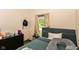 Bedroom featuring a bed with pillows, a window, and a dresser at 2702 S Moreland Ave, Indianapolis, IN 46241