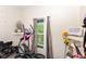 Bedroom featuring an elliptical, window with curtains, and décor at 2702 S Moreland Ave, Indianapolis, IN 46241