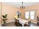 Elegant dining room with natural light, a modern chandelier, and hardwood floors, great for gatherings at 2702 S Moreland Ave, Indianapolis, IN 46241