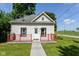 Charming one-story home with a red porch, a well-maintained lawn, and classic architectural details at 2702 S Moreland Ave, Indianapolis, IN 46241