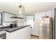 A clean kitchen featuring a stainless steel refrigerator and hood vent at 2702 S Moreland Ave, Indianapolis, IN 46241
