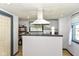 The kitchen area features laminate floors, and a large opening for serving and kitchen prep at 2702 S Moreland Ave, Indianapolis, IN 46241
