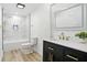 Well-lit bathroom featuring modern vanity and tiled shower with gold fixtures at 2715 S A St, Elwood, IN 46036