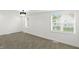 Bright bedroom with neutral carpet, white walls, windows, and a modern chandelier at 2715 S A St, Elwood, IN 46036