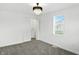 Well-lit bedroom with neutral carpet, a closet, white walls and ceilings, and a modern chandelier at 2715 S A St, Elwood, IN 46036