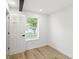 Bright bedroom with laminate flooring, white walls and door, and a window at 2715 S A St, Elwood, IN 46036