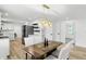 Dining area with a view into the kitchen, stylish lighting, and a modern table set at 2715 S A St, Elwood, IN 46036