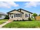 Charming single-story home boasting a stone facade, black trim, and well-manicured lawn at 2715 S A St, Elwood, IN 46036
