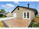 Garage featuring a stone exterior, patio area, and white garage door at 2715 S A St, Elwood, IN 46036