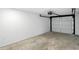 Empty garage featuring white walls, concrete floors, and a new garage door ready for storage or hobbies at 2715 S A St, Elwood, IN 46036