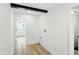 Hallway with wood flooring, white walls, and access to other rooms at 2715 S A St, Elwood, IN 46036