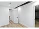 Hallway with wood flooring, white walls, and black accent beam at 2715 S A St, Elwood, IN 46036