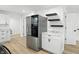 Bright kitchen features modern stainless steel refrigerator, white cabinets, and attractive countertops at 2715 S A St, Elwood, IN 46036
