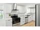 Modern kitchen featuring white cabinets, stainless steel appliances, and marble countertops at 2715 S A St, Elwood, IN 46036