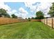 Large backyard featuring healthy lawn and wooden fence perimeter at 2724 N Dearborn St, Indianapolis, IN 46218