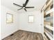 This bedroom features laminate flooring, two windows, and a ceiling fan at 2724 N Dearborn St, Indianapolis, IN 46218