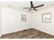 Bedroom with hardwood floors, modern ceiling fan, and dual window views at 2724 N Dearborn St, Indianapolis, IN 46218