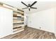 Bright bedroom features wood-look floors, stylish accent wall, and modern ceiling fan at 2724 N Dearborn St, Indianapolis, IN 46218