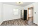 This dining area features durable wood-look flooring and stainless steel refrigerator near the doorway at 2724 N Dearborn St, Indianapolis, IN 46218