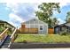 Charming home featuring light-blue siding, wood accents, and a wooden porch at 2724 N Dearborn St, Indianapolis, IN 46218