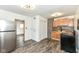 Open kitchen with stainless steel appliances, hardwood floors and updated cabinets at 2724 N Dearborn St, Indianapolis, IN 46218