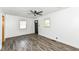 Bright living room with hardwood floors, a ceiling fan and large windows at 2724 N Dearborn St, Indianapolis, IN 46218