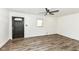 Spacious living room with hardwood floors, white walls, front door and ceiling fan at 2724 N Dearborn St, Indianapolis, IN 46218