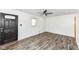 Bright living room with hardwood floors, white walls and a modern ceiling fan at 2724 N Dearborn St, Indianapolis, IN 46218