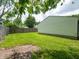 A spacious, grassy backyard is enclosed by a wooden fence, with a storage shed along one side at 2909 S Randolph St, Indianapolis, IN 46203