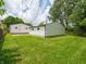 Backyard of property with large yard, grassy lawn and view of the detached garage at 2909 S Randolph St, Indianapolis, IN 46203