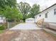 A spacious backyard featuring a detached garage, gravel parking and lush greenery at 2909 S Randolph St, Indianapolis, IN 46203