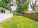 The backyard has a grassy lawn and a wood fence that runs along the property line at 2909 S Randolph St, Indianapolis, IN 46203