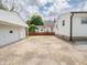 Backyard featuring a long concrete driveway to the detached garage and white home at 2909 S Randolph St, Indianapolis, IN 46203