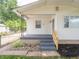 Close up of the home's freshly painted exterior, front porch, and small, landscaped garden at 2909 S Randolph St, Indianapolis, IN 46203