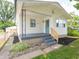 Close up of the home's freshly painted exterior, front porch, and small, landscaped garden at 2909 S Randolph St, Indianapolis, IN 46203