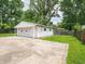 The detached two-car garage has a concrete driveway, lawn, and shade trees at 2909 S Randolph St, Indianapolis, IN 46203