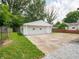 Detached two-car garage with concrete driveway and lawn, surrounded by mature trees at 2909 S Randolph St, Indianapolis, IN 46203
