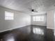 Spacious living room with shiny hardwood floors, large windows, and ceiling fan at 2909 S Randolph St, Indianapolis, IN 46203