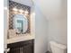 Elegant half bath with a modern vanity, stylish mirror, and unique wallpaper, offers a touch of sophistication at 296 Myers Lake Dr, Noblesville, IN 46062
