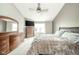 Spacious bedroom with a dresser, television, ceiling fan, and large window providing lots of natural light at 296 Myers Lake Dr, Noblesville, IN 46062
