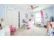 Charming bedroom featuring a ceiling fan, a large closet, and playful decor on light blue walls at 296 Myers Lake Dr, Noblesville, IN 46062