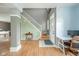 Inviting foyer with hardwood floors, white staircase, and natural light creates a warm welcome to this charming home at 296 Myers Lake Dr, Noblesville, IN 46062