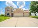 Charming brick home featuring a three-car garage, well-maintained lawn, and inviting curb appeal at 296 Myers Lake Dr, Noblesville, IN 46062