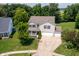 Aerial view of a charming home with a lush backyard, spacious driveway, and mature trees at 3058 Mcintosh Dr, Bargersville, IN 46106
