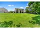 A large, green backyard lawn with a view of the rear of the home at 3058 Mcintosh Dr, Bargersville, IN 46106