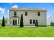 View of the home's rear exterior, patio, and manicured lawn at 3058 Mcintosh Dr, Bargersville, IN 46106